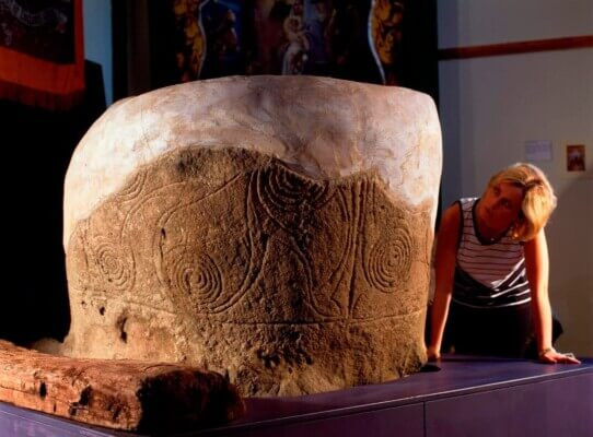 a girl looking at a large stone Cavan: Ireland