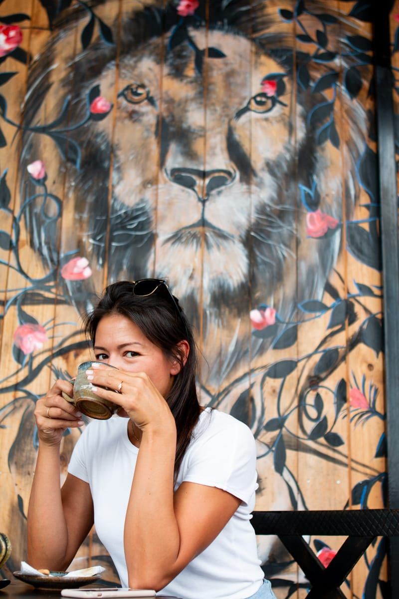 Kim drinking coffee from Imigongo Art Cafe