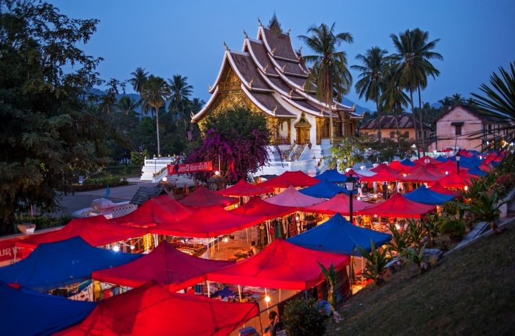 Vientiane Night Market in Laos offers a vibrant atmosphere where visitors can explore a wide array of stalls selling traditional Lao products, clothing, and local snacks, creating a lively cultural experience along the Mekong River.