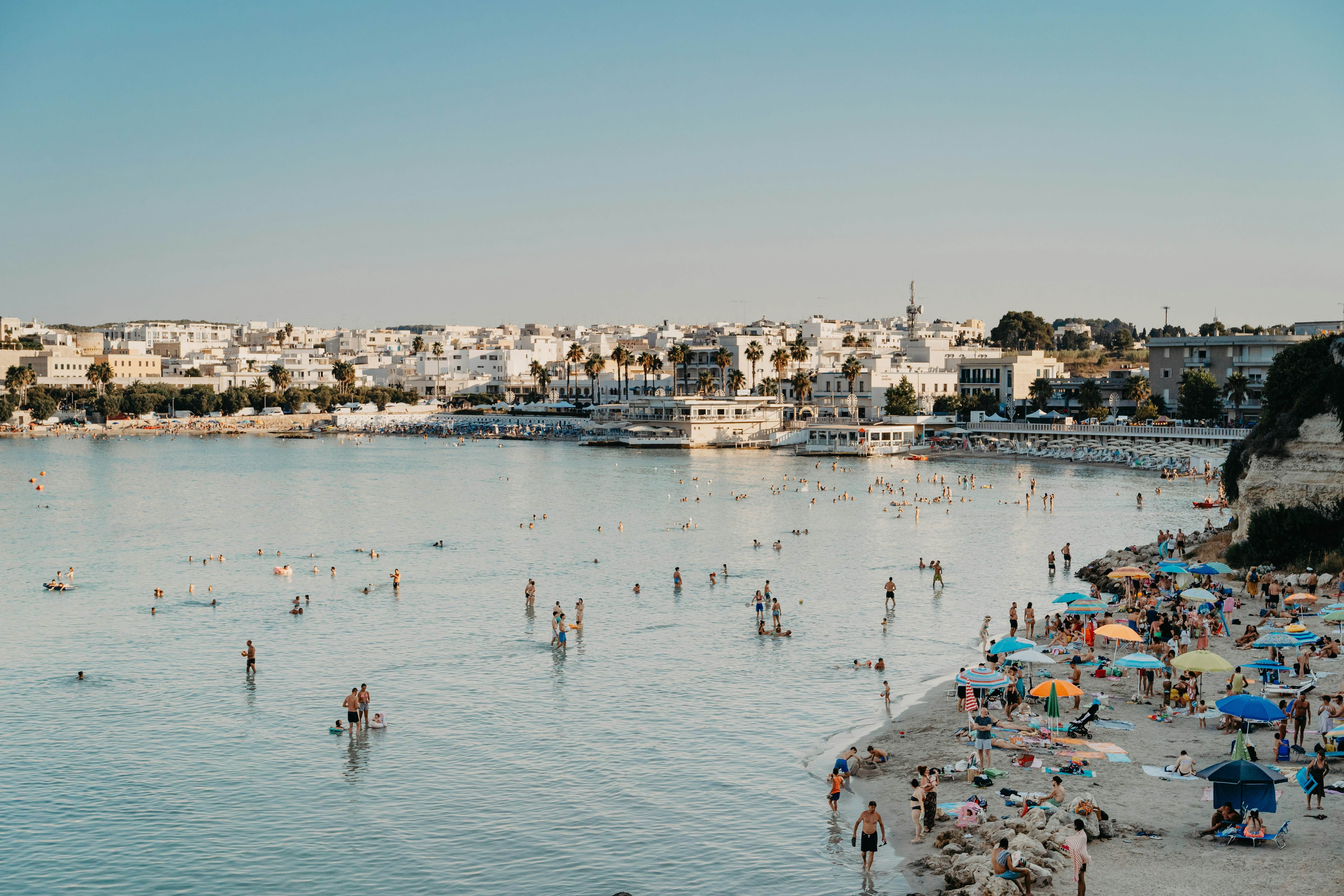 Crowded beach in Puglia, Italy, highlighting the summer tourist influx