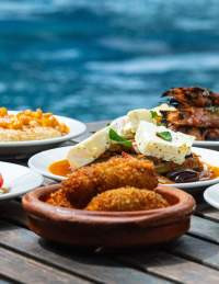 Selection of small plates on a table by a swimming pool in Bristol