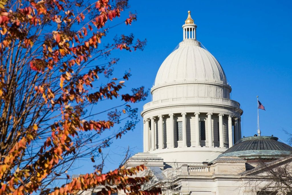 The dome of the capitol building in Little Rock, Arkansas silhouetted against a bright blue sky. Little Rock is the capitol of Arkansas and is located in the region of Arkansas called Central Arkansas.