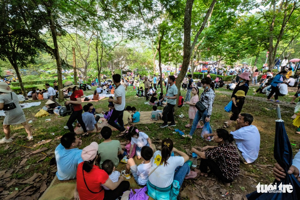 Visitors picnic at the Hung King Temple relic site in Phu Tho Province, Vietnam, April 21, 2021, depicting families enjoying leisure time during the cultural event