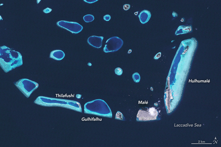 Maldives atoll panorama with crystal-clear water