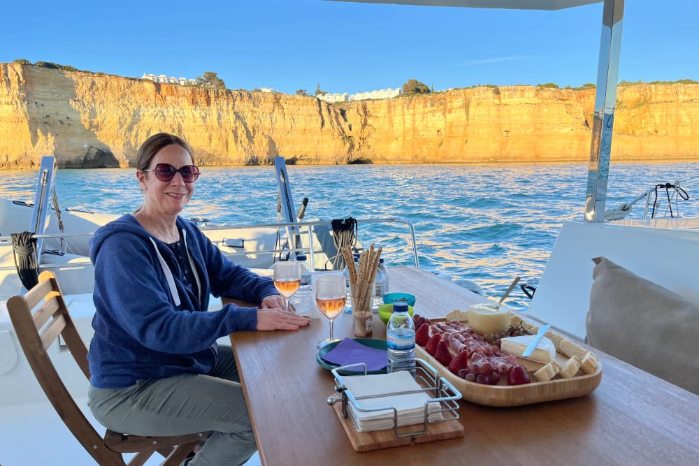 Travelers enjoying a private yacht cruise in Portugal during sunset, showcasing the scenic beauty and relaxation.