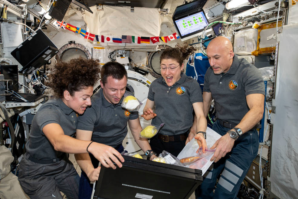 Jessica Meir, Andrew Morgan, and Christina Koch with Luca Parmitano.