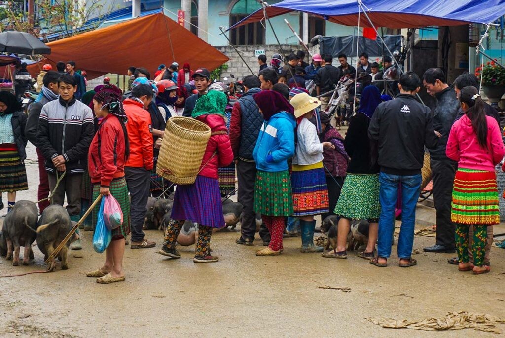 A bustling scene at Meo Vac Market, showcasing the vibrant colors and lively atmosphere of the local culture