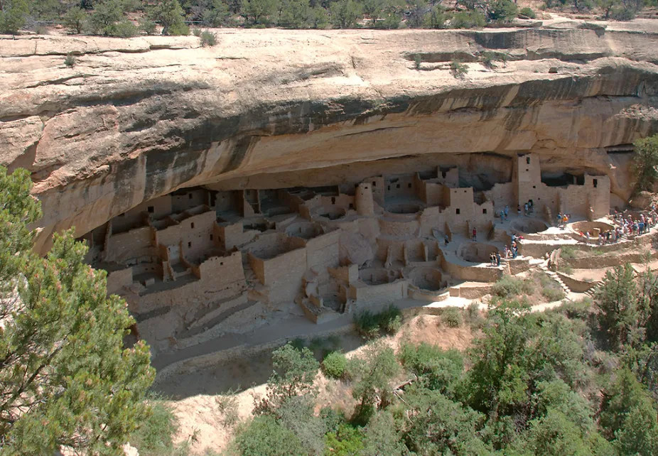 Cliff dwellings at Mesa Verde National Park, built in the shadows of rock overhangs to keep the structures cool in the hot desert sunlight, showcase ancient solar design principles.