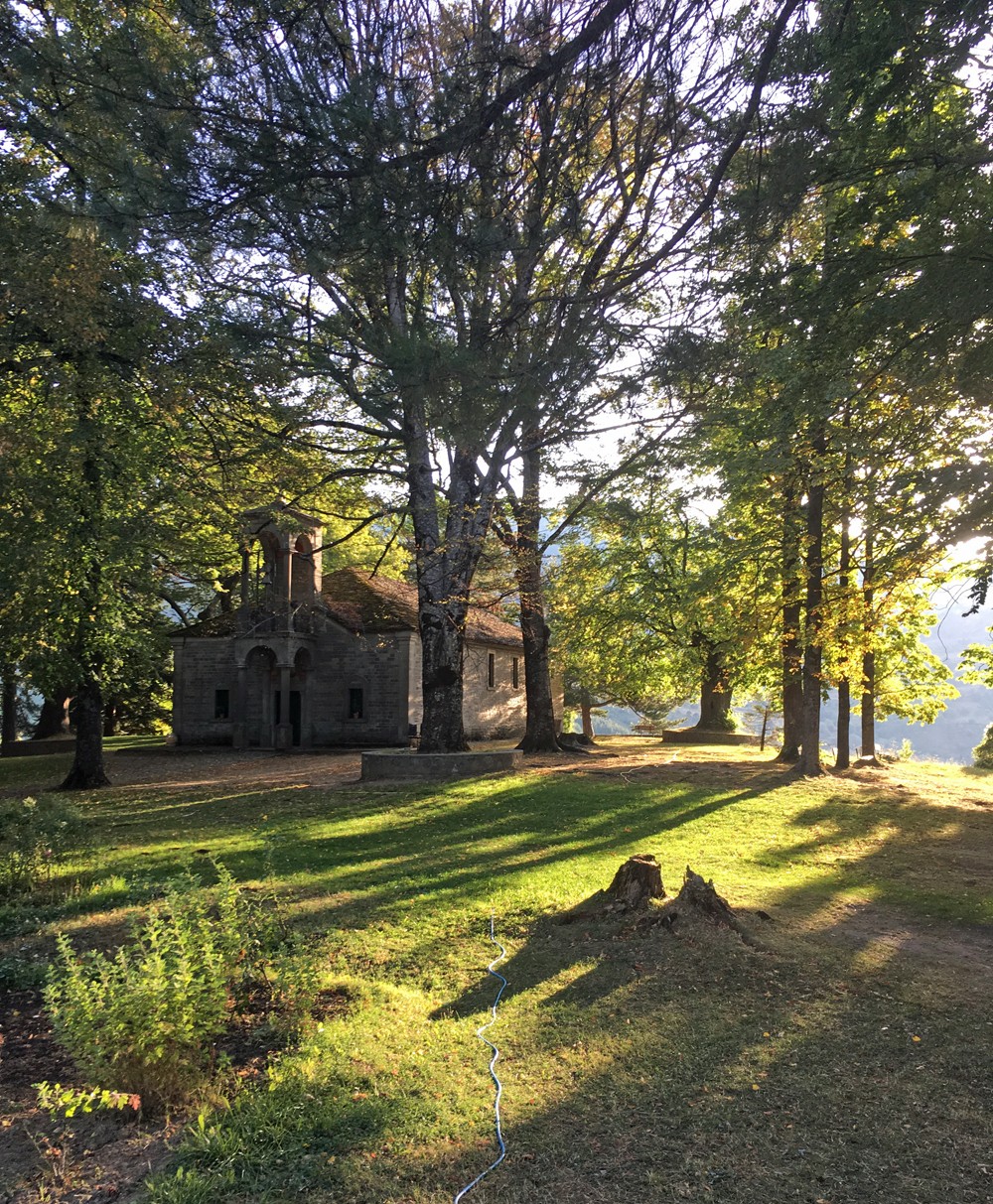 Morning light shines on the chapel of Ayios Georgios in the Averoff Garden, a 10 acre botanical park of Pindos tree specimens near the heart of the village created in 1913 (the date Epirus joined the nation state of Greece)