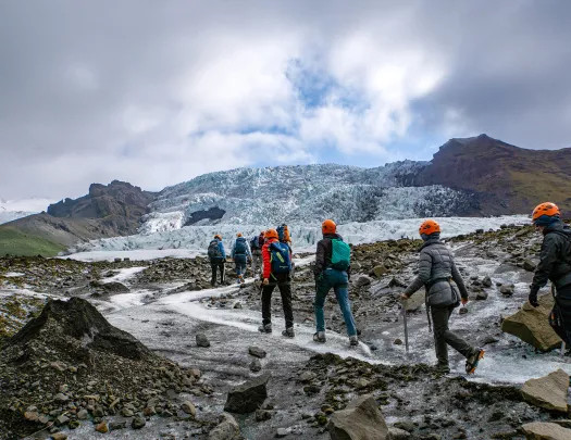 Adventurers hike near Iceland's glacial coast