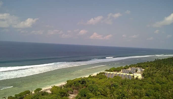 Minicoy Island offers a stunning view of its lighthouse against the blue sea, inviting visitors to explore one of Lakshadweep's most iconic spots.
