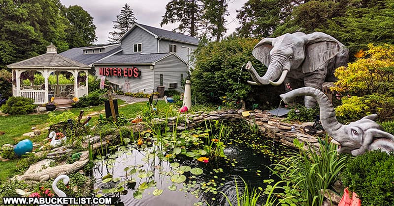 An elephant-themed water garden in front of Mister Ed