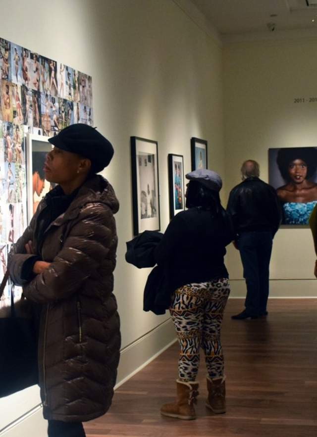 Art enthusiasts appreciate artwork displayed at a Mobile, AL art gallery