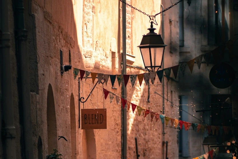 Decorative banners on a narrow street in Montpellier. 