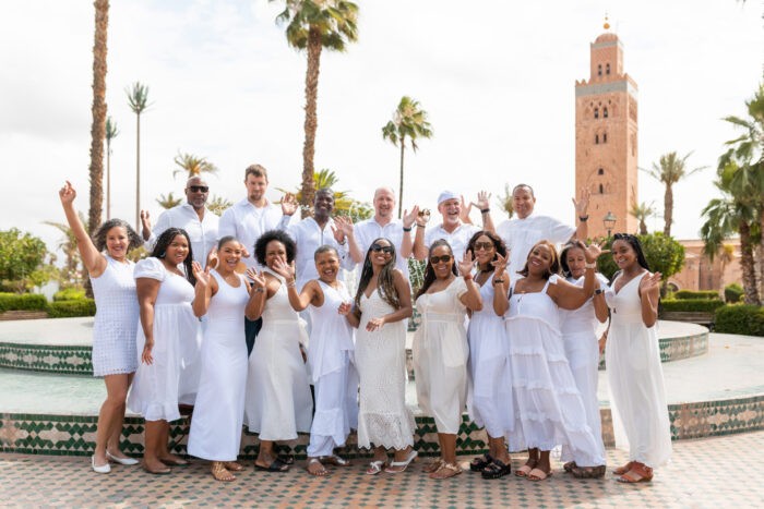 Group picture with the Kutubiyaa minaret in Marrakech, highlighting the iconic landmark and vibrant city atmosphere