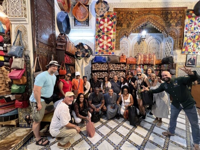 Group in a leather shop, highlighting the variety of leather goods available in Morocco