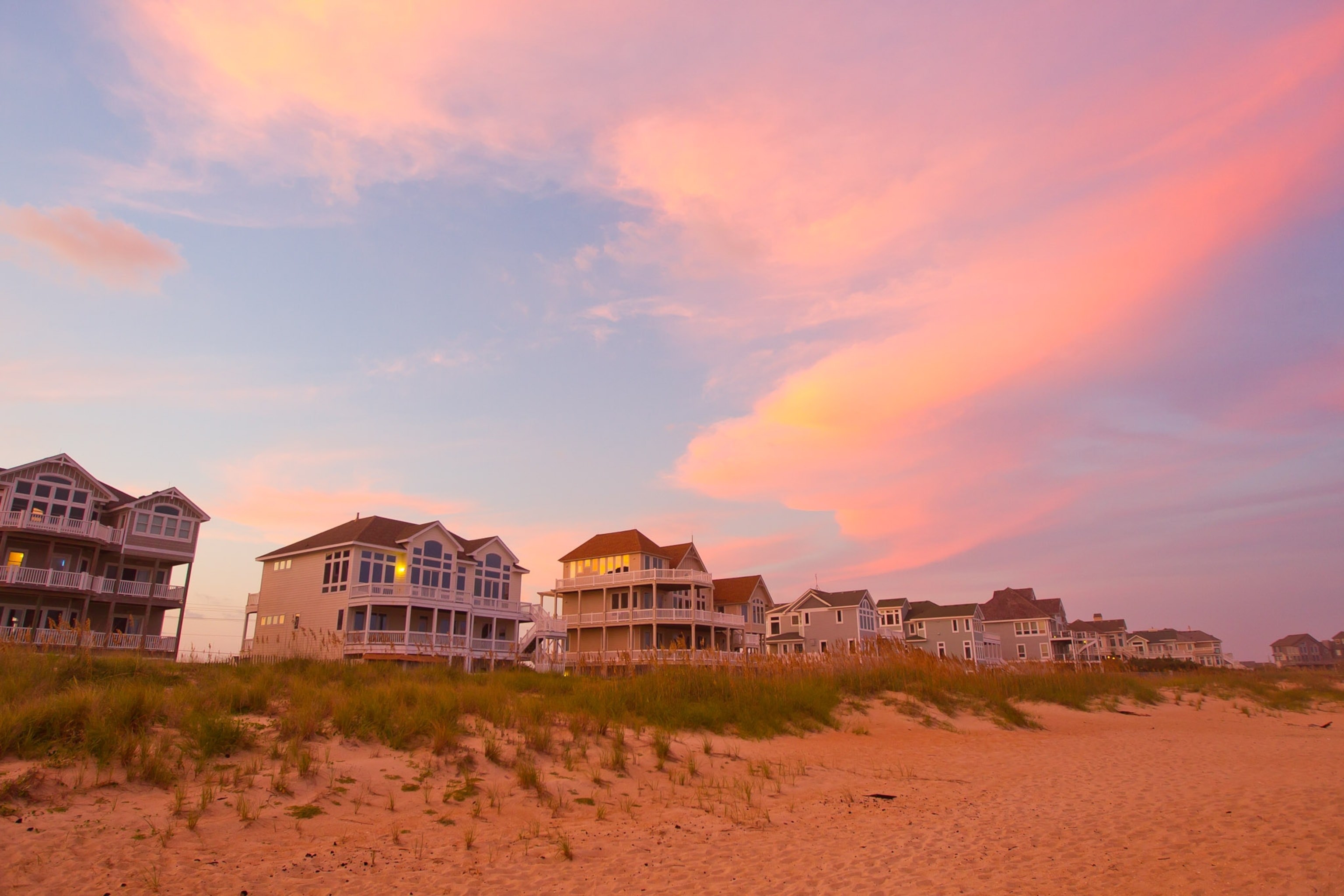 A beach and the sea at sunset.