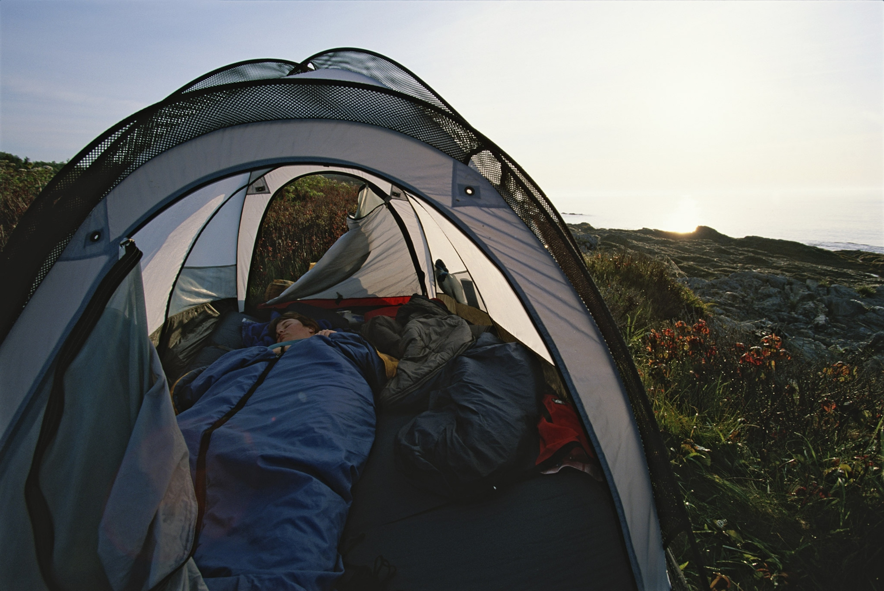 A woman sleeping in a tent on Jewell Island