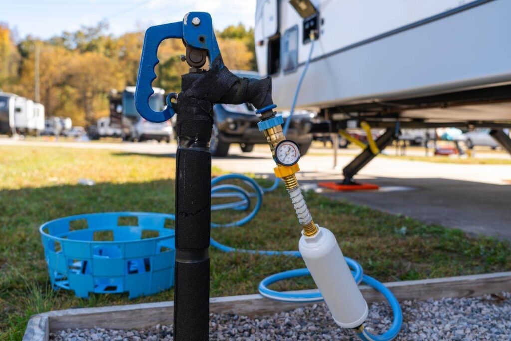 RV connected to water spigot with regulator and filter