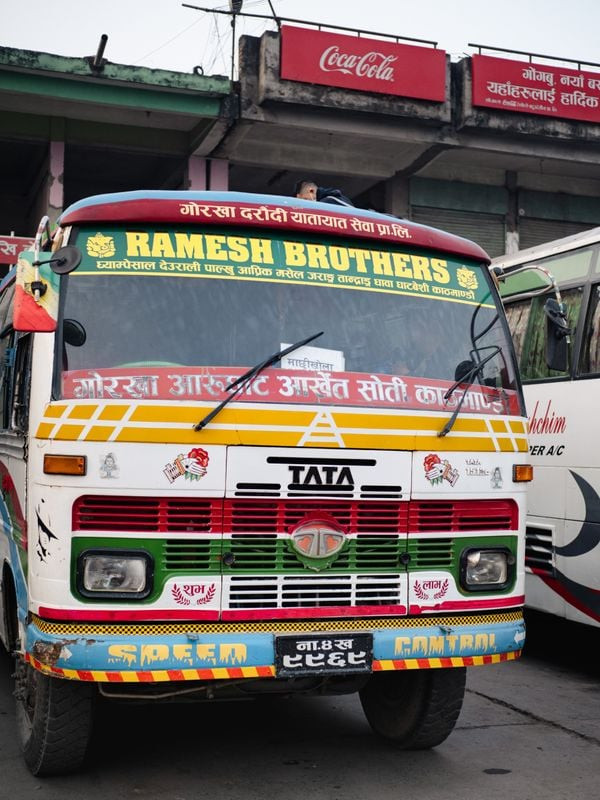 A brightly-coloured bus, preparing for a long journey to Jagat. Photo: Sarah Hewitt