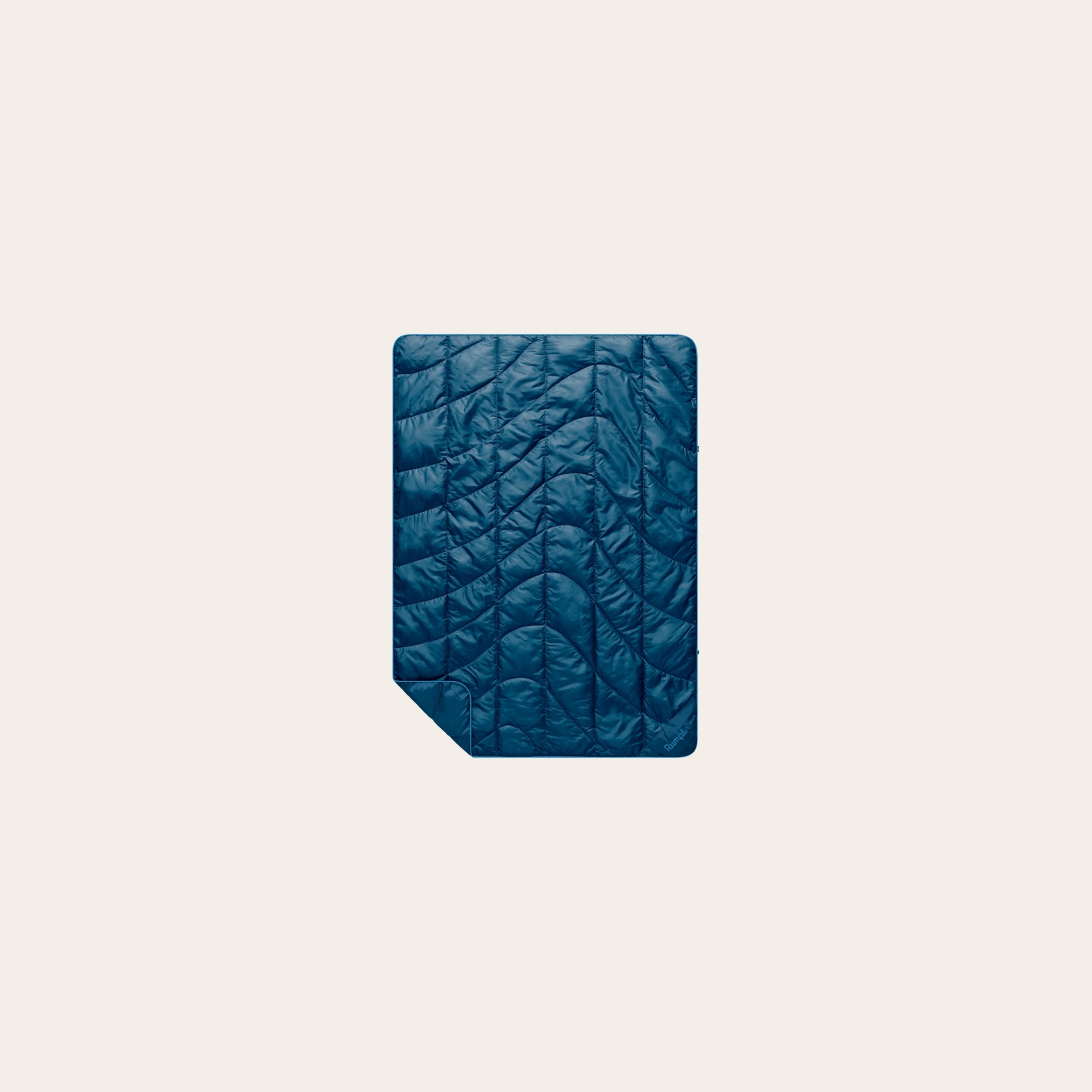 Rumpl NanoLoft Travel Puffy Blanket packs into a roll-top stuff sack and is made from recycled materials.