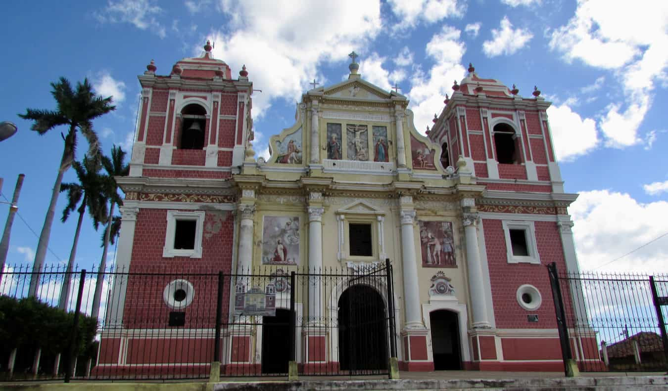 A vibrant street scene captured during a free walking tour in Leon, Nicaragua, where participants learn about the city's history and culture