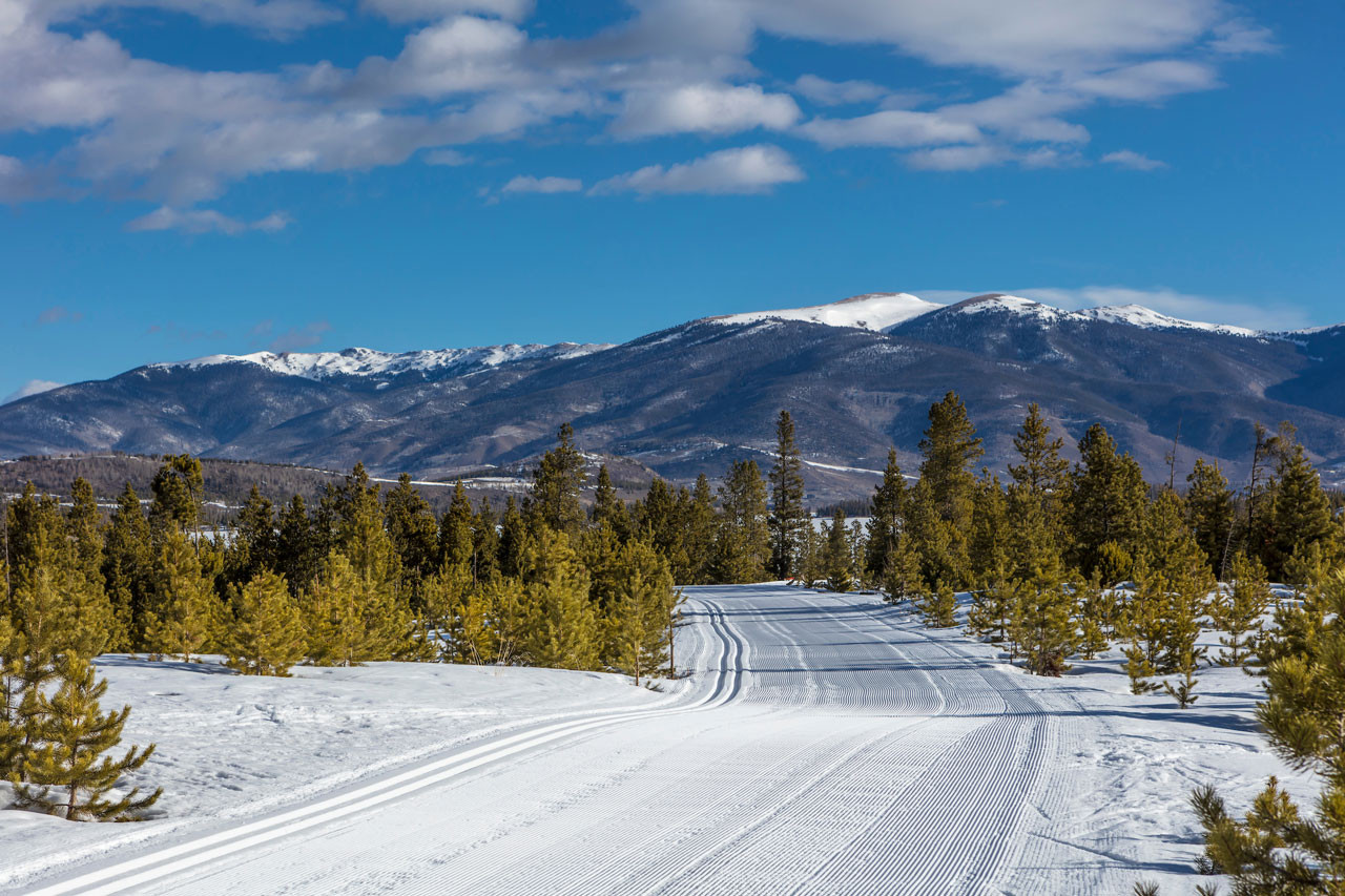 Freshly groomed trail on sunny winter day.
