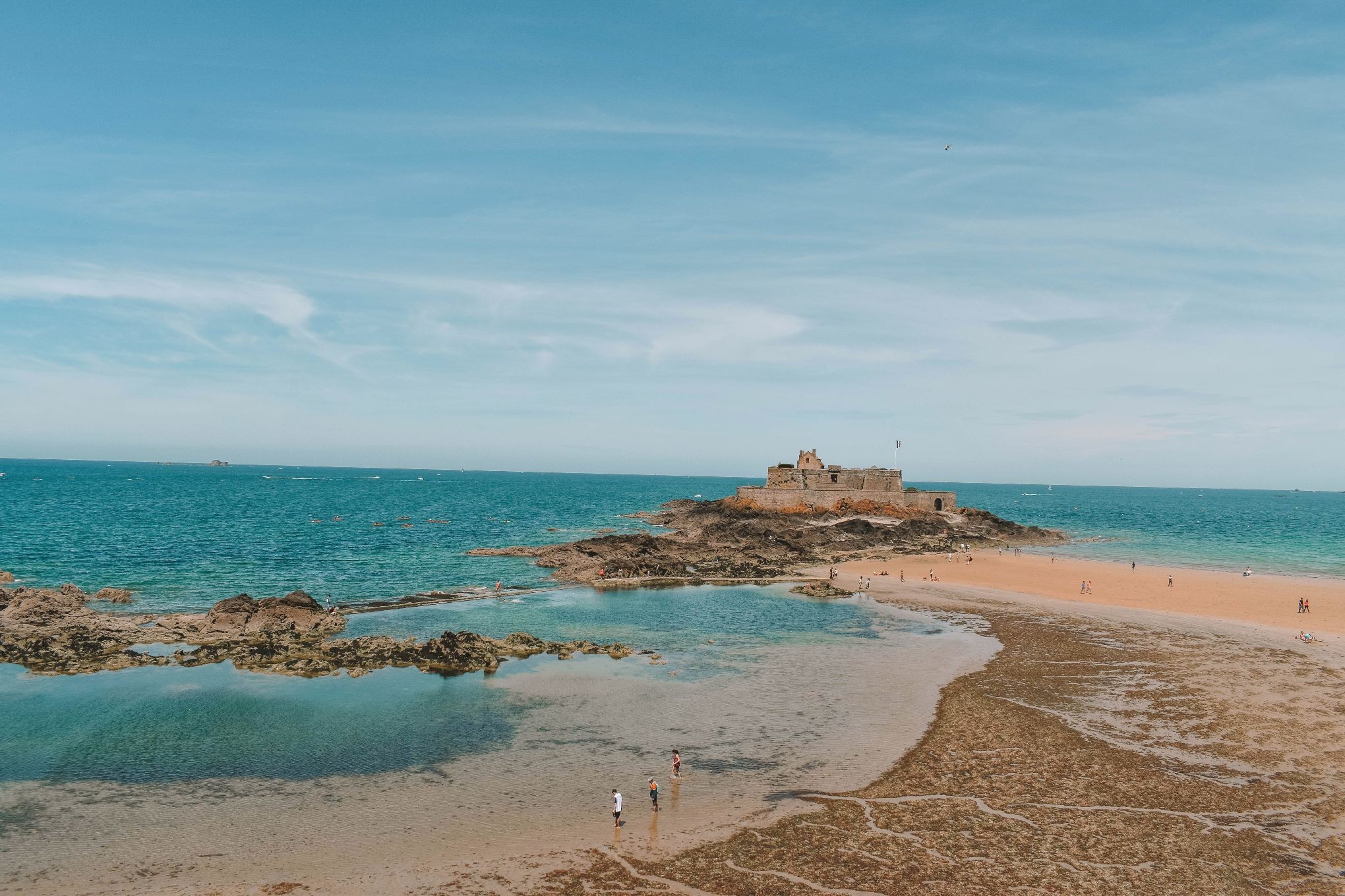 Ramparts in Saint-Malo with crystal clear blue water, showcasing the city's stunning coastal beauty