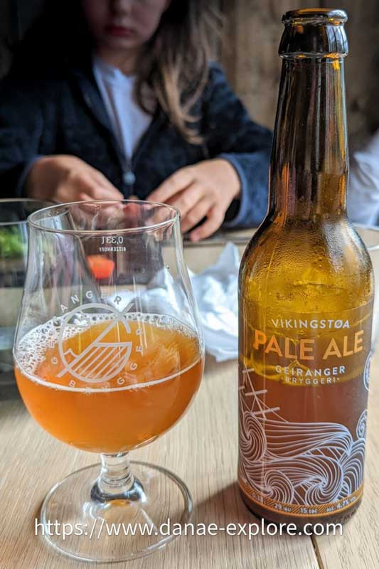 Glass and bottle of Geiranger beer, in restaurant in Geiranger Fjord, Norway.