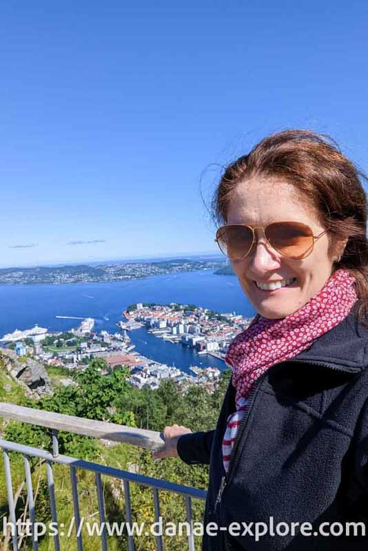 Bergen, view from the funicular. Caucasian girl with sunglasses, red scarf and black blouse looking at camera