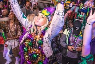 Woman with Hands in the Air at a Mardi Gras Parade