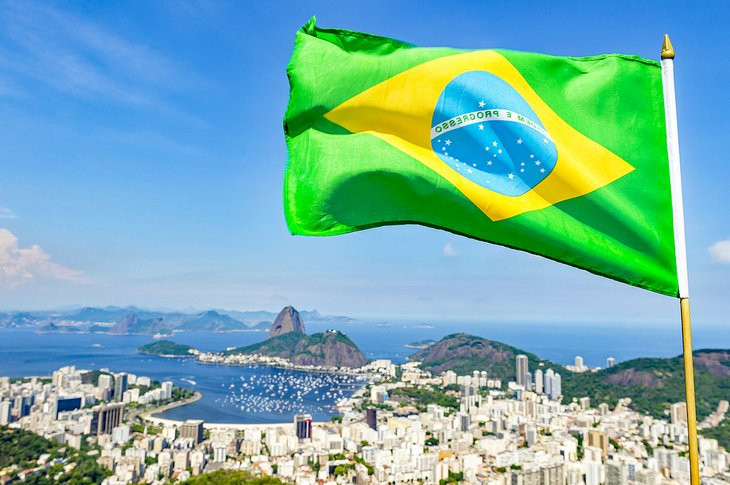 Brazilian flag flying above Rio de Janeiro, symbolizing its vibrant culture and stunning landscapes
