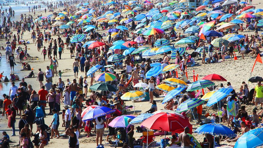 Crowded beach illustrating overtourism