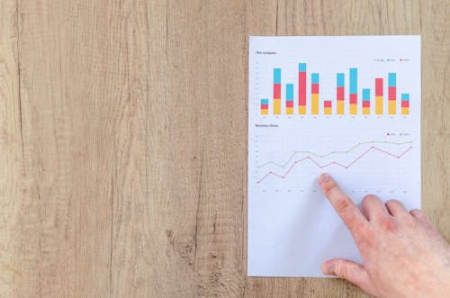 Man writing financial data while analyzing business strategy