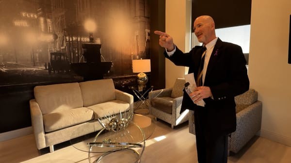 Hotel on Phillips front desk manager Phil Zea explains the historic photograph of downtown Sioux Falls featured, S.D., on the wall of one of the rooms during a tour for SDPB on Jan. 31, 2025