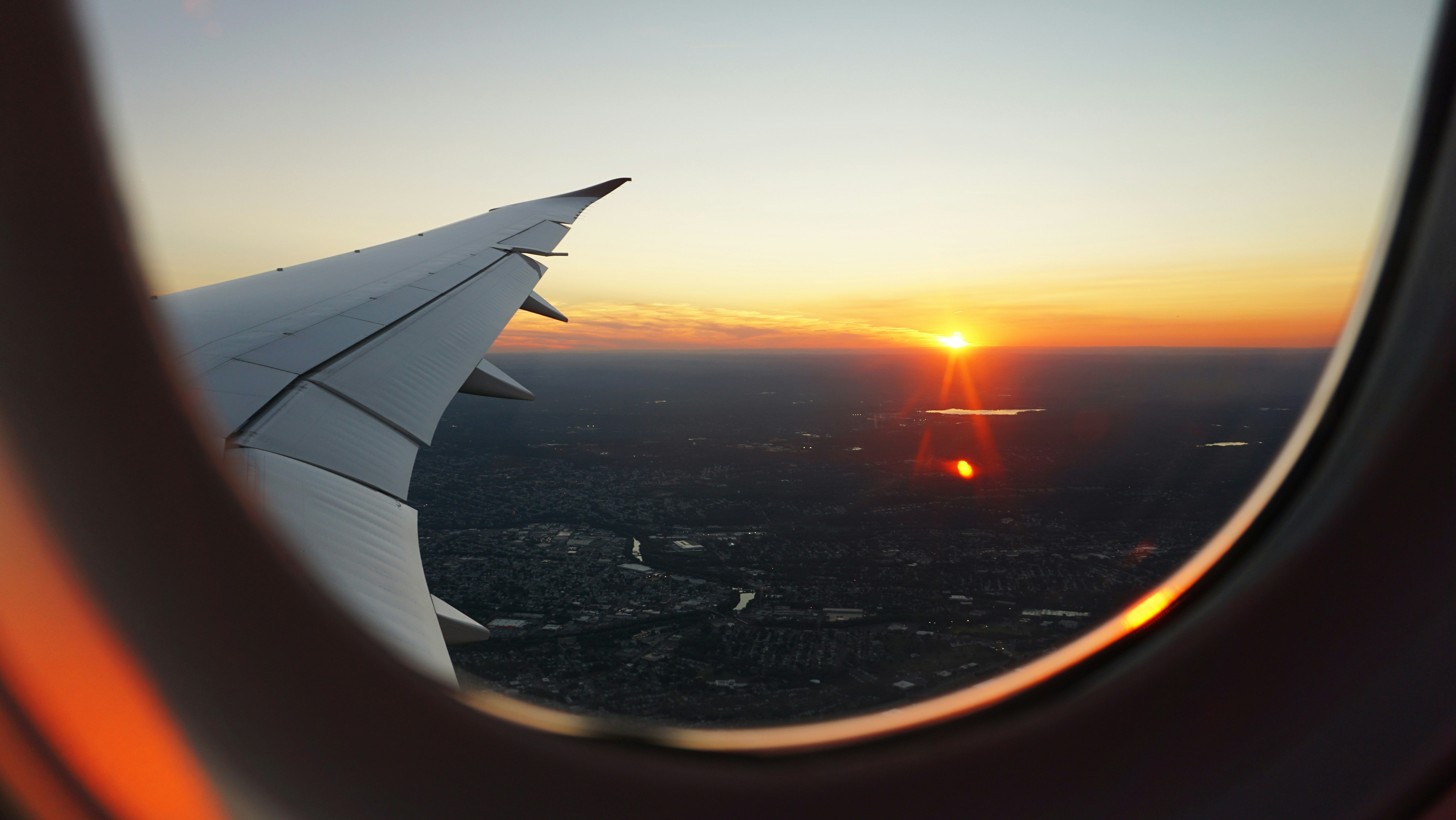 airplanes window view of sky during golden hour, Sunset seen from a plane