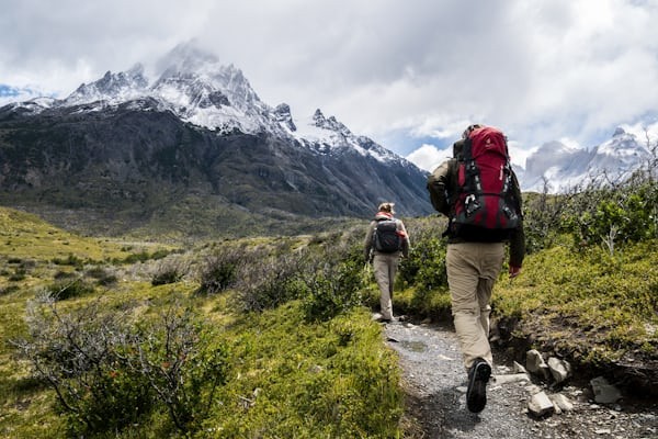Woman hiking with a backpack in a mountainous landscape