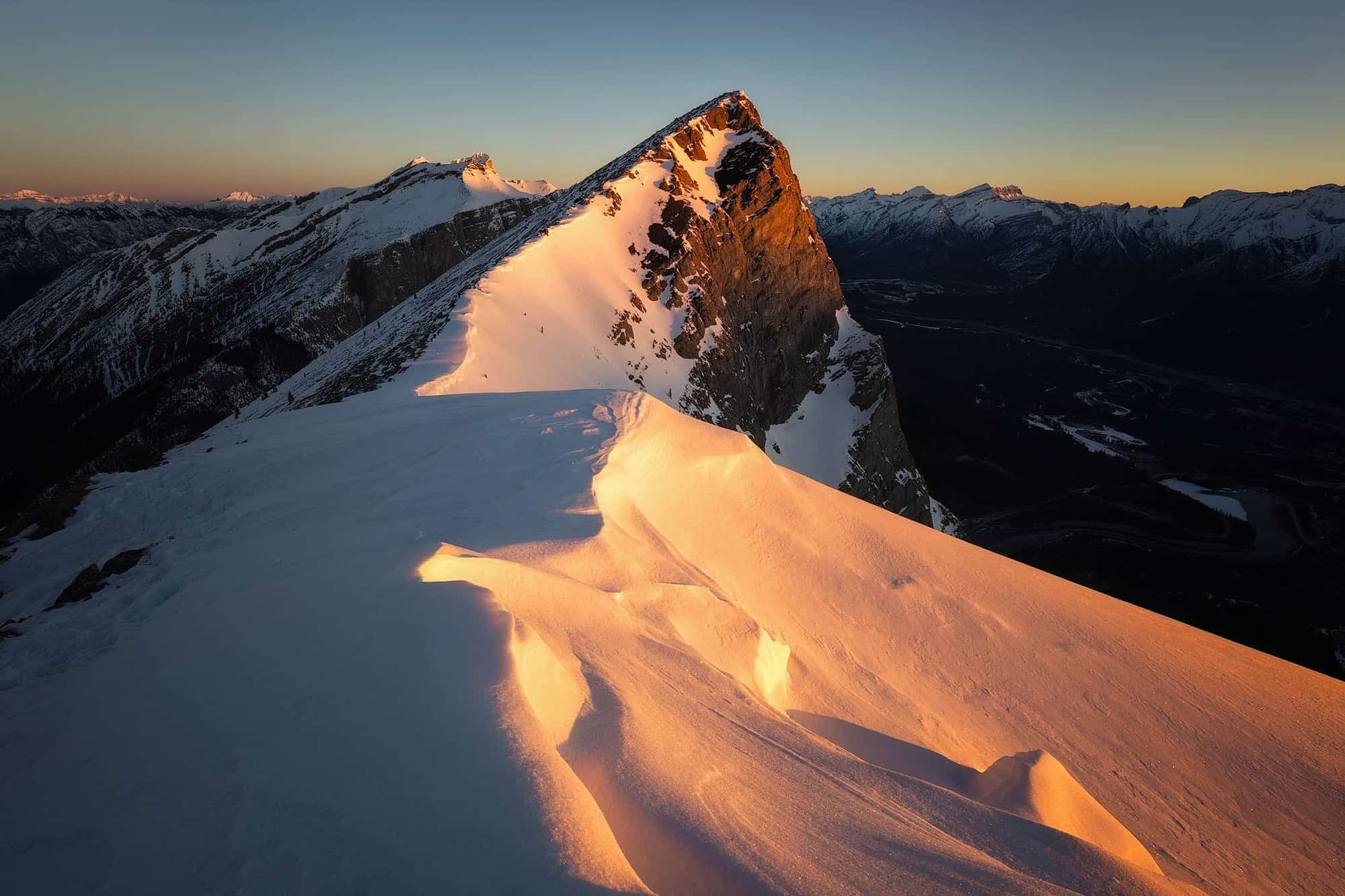 The rays of light tickling the snow on Ha Ling Peak