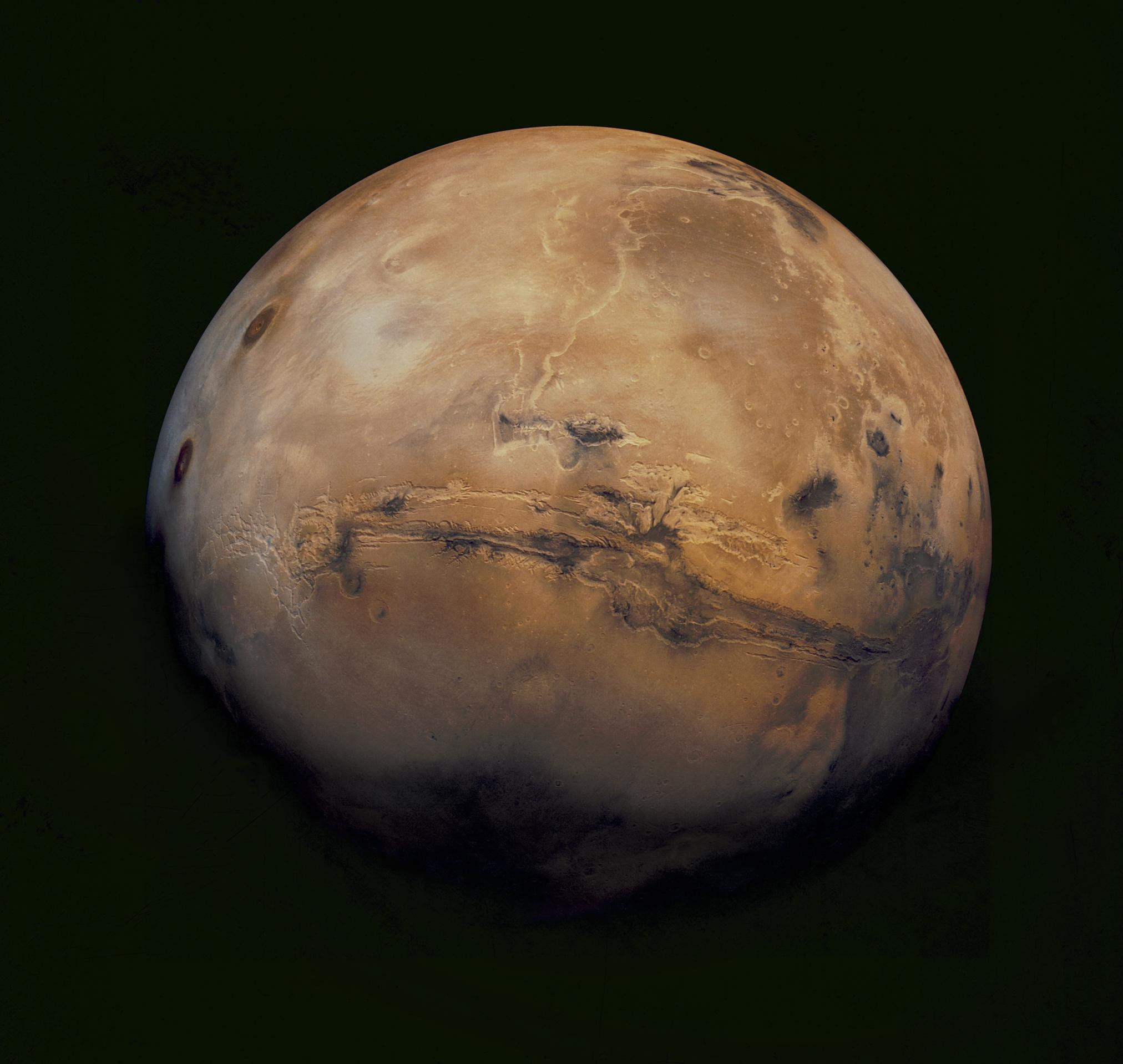 The Red Planet featuring a large crater in the center.