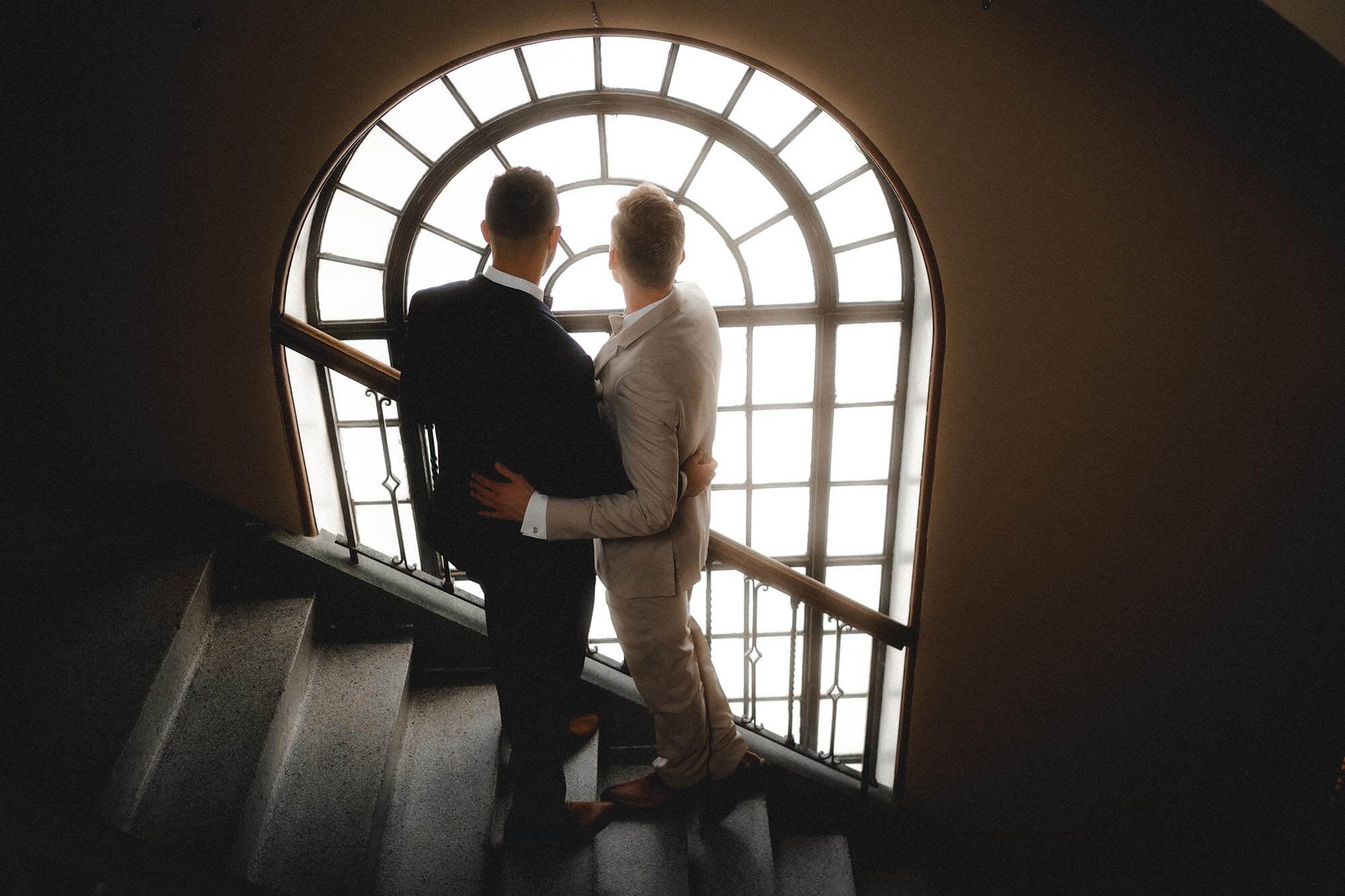 The Window: A bride and groom pose by the window at Lafayette Grande