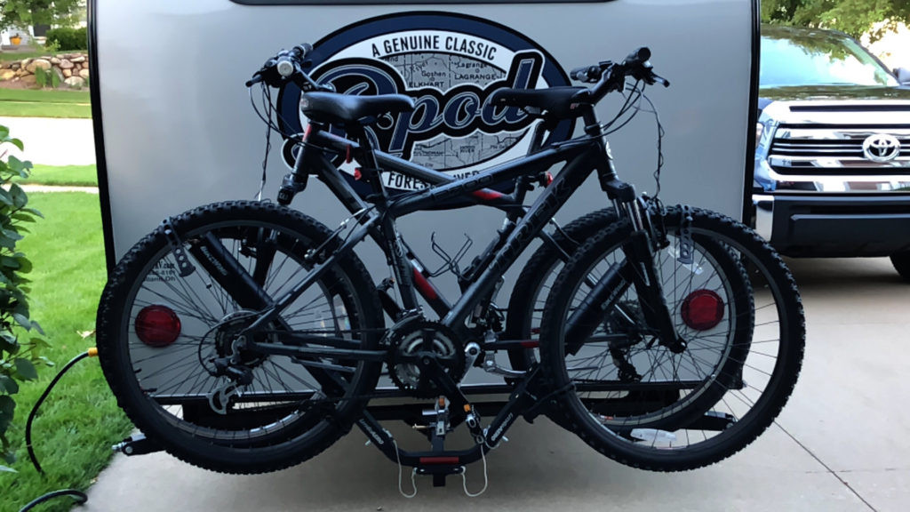Bikes on a hitch attached to the back of an RV, showing how a hitch extender can be used