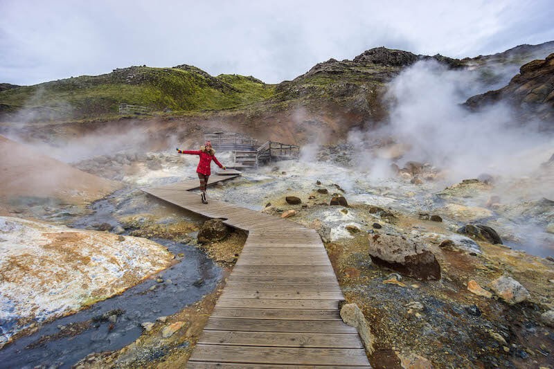 Woman standing in a field in Iceland, enjoying the scenery