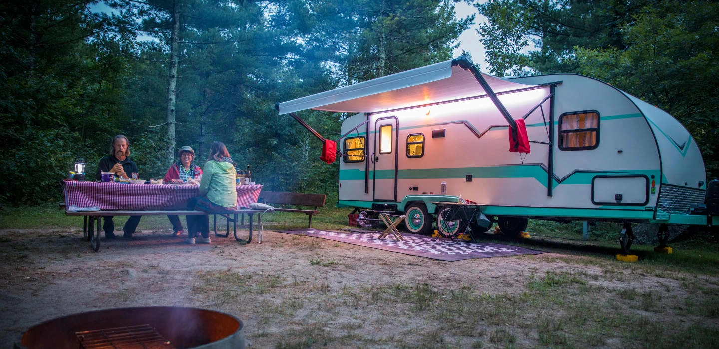 Level travel trailer with happy RVers