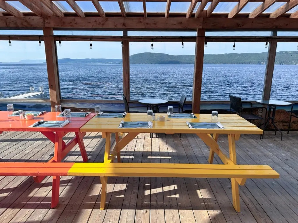 Picnic tables on the waterfront patio at the Saltbox in Benoit