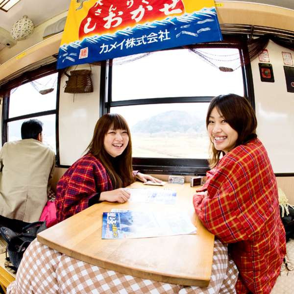 Sanriku Railway Retro Train interior showing retro-style decor and train attendants in Showa Period attire, offering a nostalgic travel experience