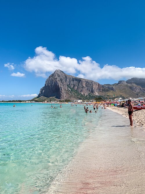 Scenic coastal road in Sicily with a rental car driving along the seaside