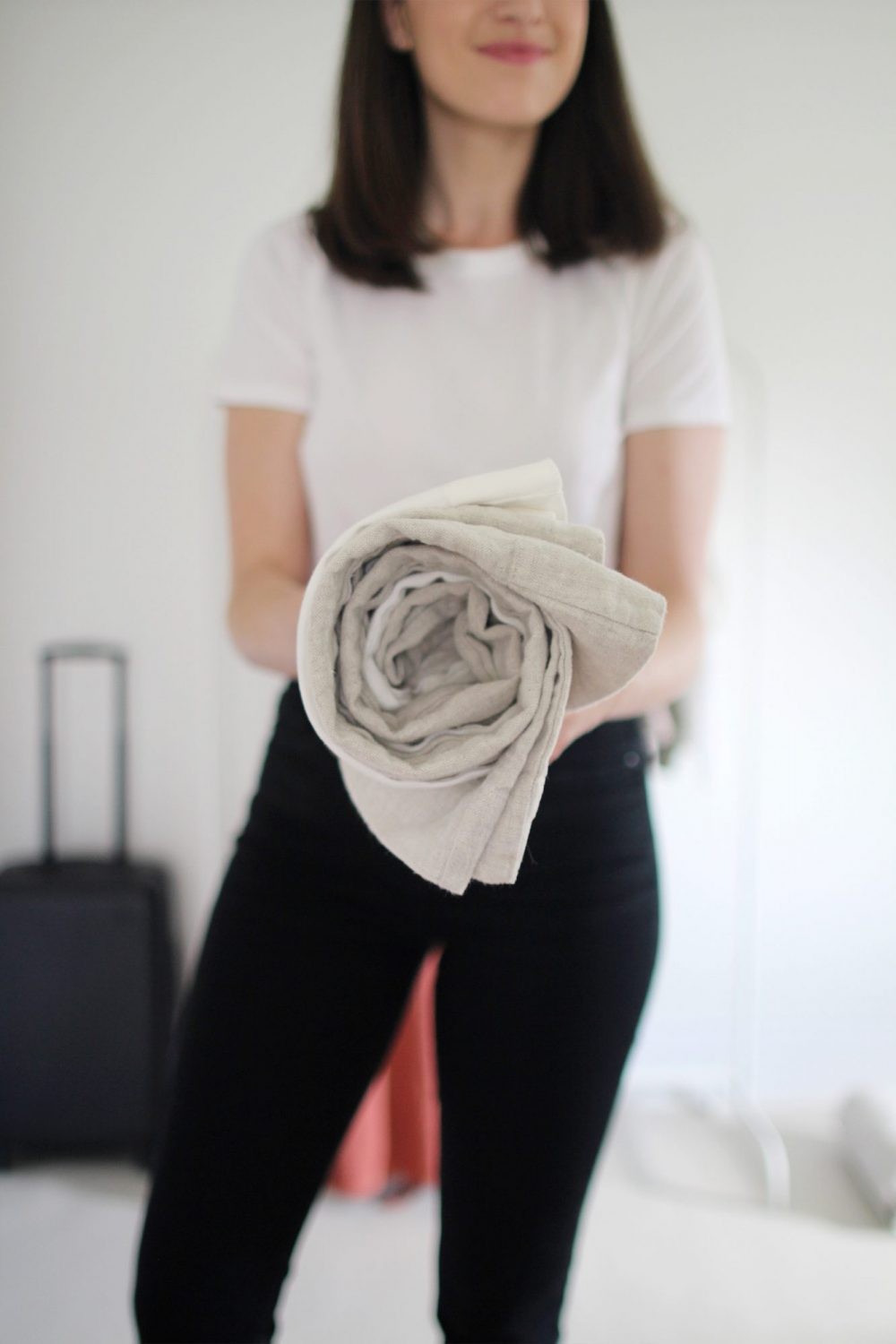 Smoothing out linen while rolling