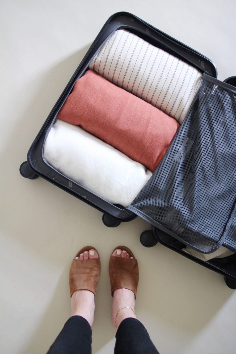 Placing linen rolls in a suitcase
