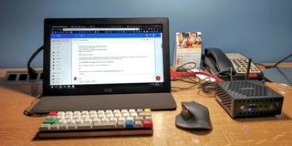 Zotac mini PC with a portable monitor set up in a hotel room