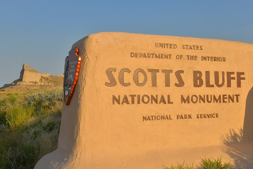 Scott Bluff Alt Text: A panoramic view of Scotts Bluff National Monument in Nebraska, showcasing towering bluffs against a clear sky, drawing hikers and nature lovers to explore the rugged beauty of the Great Plains.